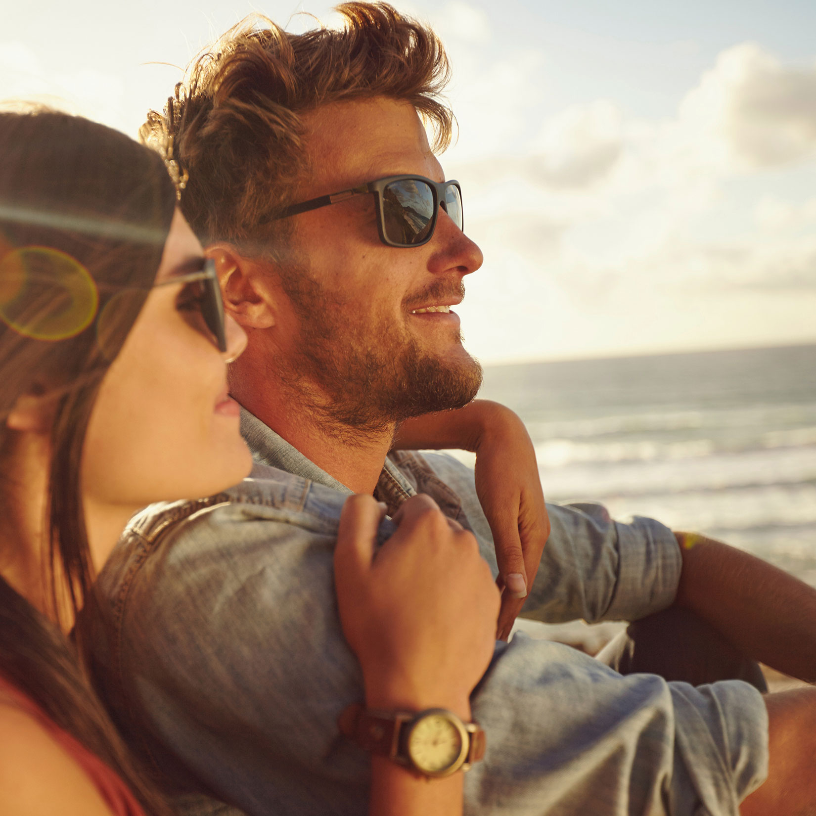 close up of a woman and a man by a sunny waterfront