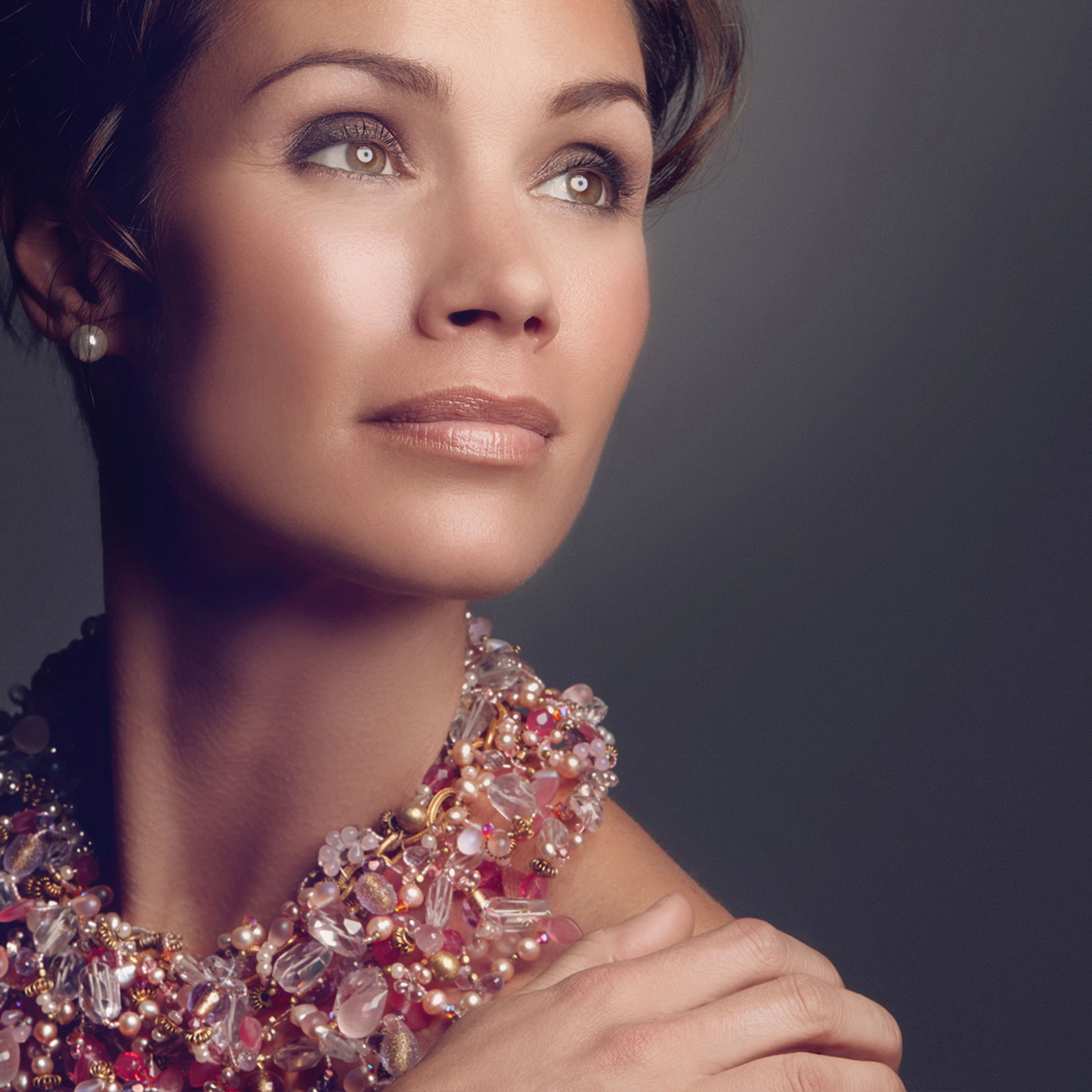 close up of a woman with her hand on her shoulder