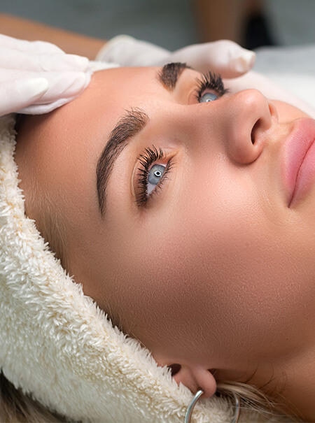 woman after receiving brow and lash treatments