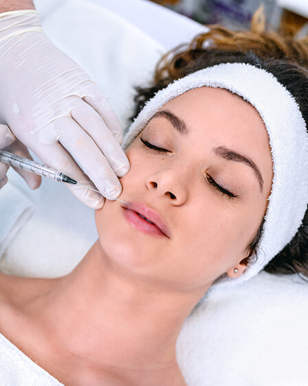 woman in spa receiving dermal filler in lip
